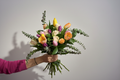 Floral bouquet held by hand